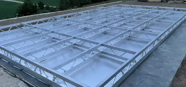 Baubild einer begehbaren Poolabdeckung mit Wasserablaufblechen für den Regenwasserablauf